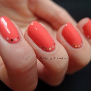 Coral nail polish with jems Aline the bottom of the nails