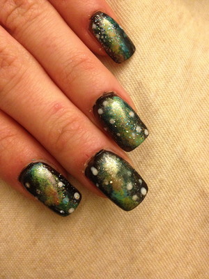 black nail polish. light blue, yellow, and pink stippled on top. white stars and blue and god glitter polish on top