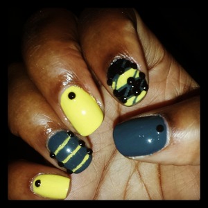 Yellow,  black, and grey nails.