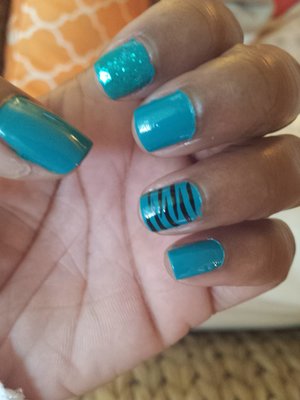 teal nails with glitter and zebra print