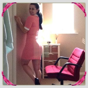 Me in a peach fitted dress, white collar, and white piping around the sleeves, natural legs, and little make up