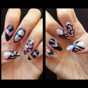 Holographic pink glitter acrylic stilettos with some simple funky line designs. This is my favorite set ive done in a while :)