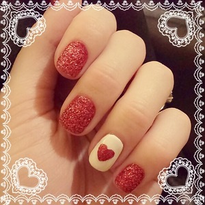 dipped glitter nails with a simple glitter heart a on white nail polish 
xoxo