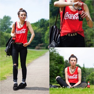 Red sleeveless shirt, featuring round neckline, sleeveless, contrasting "Coca Cola" print on chest, loose styling.