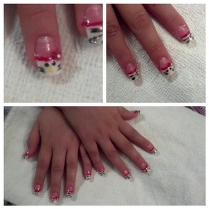 white tips with zebra printing and the middle finger with the hello kitty face and the bow 3D