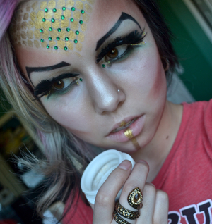 A natural, earthy pallet for the eyes symbolizing the Taurus element of Earth. Emerald jewels for envy, and gold shine for greed, the Taurus has imperfections that stem from her need for beauty and money. Ruled by Venus, the copper-tone shadows have harsh edges that symbolize the hard-headedness of the bull. A gold path on the lip shows a taste for fortune and luxury. My name is Jayde and I am proud to be a Taurus.