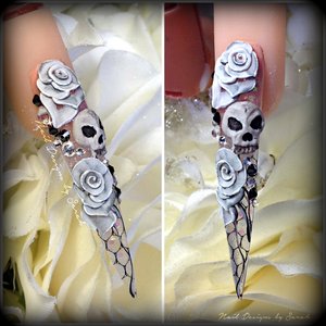hand made 3D skulls and roses on a stiletto nail with real net encapsulated in the stiletto 
