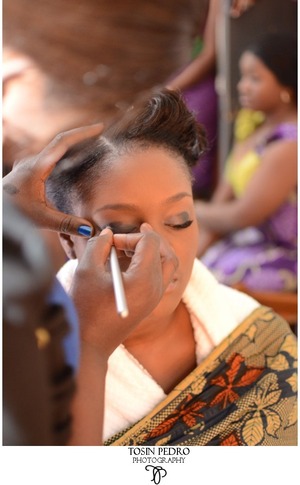 a bride getting made-up on her wedding day.