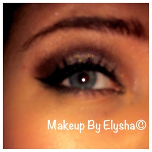 A look using Bobbi Brown Cream Shadow in Antique Gold on the lid, Lorac 3D Diamond Luster Drops over the cream shadow, MAC Blackberry in the crease and outer V and Carbon and Embark to darken the outer V. Line with a wing on top, smudge liner on bottom, apply mascara and enjoy