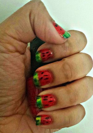 Here is some watermelon nail art I did. You should try it. I guarantee you will get complements. All you have to do is paint your nails red, do green french tips with stripes and add black dots to the red.