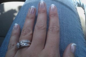White tip manicure with a pearl top coat and a silver separation line