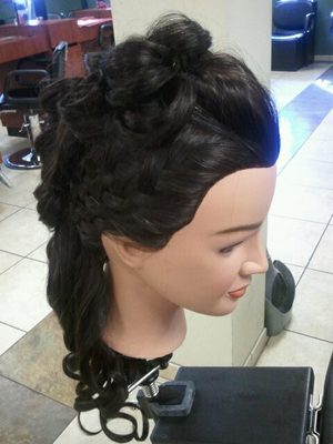 Both sides were basket weaved, pulled into a mohawk of pin curls and then the ends curled.
