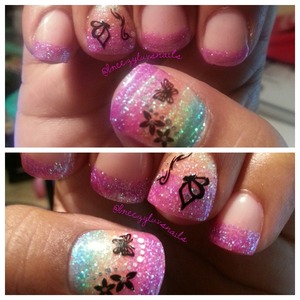 Gell nails with a glitter french tip and encapsulated kiss nail art sticker.