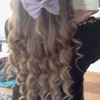 Curled hair with purple bow