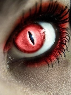 This is a contact, which is red, and only allows a slit of black around the iris to show. So, it needs the red glaze around the eyes, and the lashes were meant to be spidery to give it even more of a creepy edge.