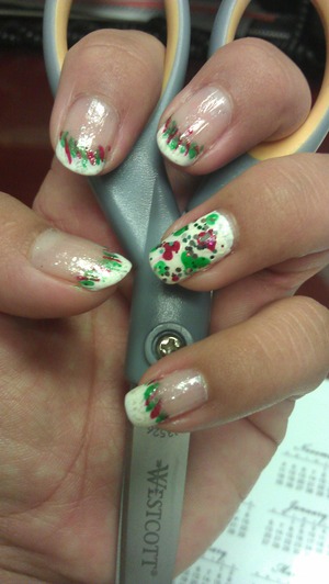 white tips with diagonal red and green strips. Ring finger with red and green spots and glitter on top. 