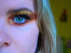 Orange, Yellow and Gold Shadows with Black EyeLiner to Create leopard eyes :)