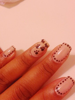 Nude nail color with black dots and paw prints and dog shaped nail art