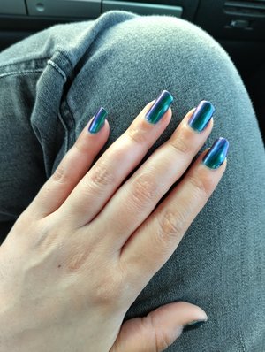 This is Origin Unknown by Cirque Colors. I absolutely love the shift in hues this has. Photos don't do it justice. It's primarily a deep metallic forest green that turns a deep ocean blue at certain angles and has a slight purple shift.