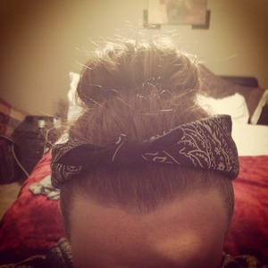 Sock bun, roll from the top of your hair down then bobby pin it and to make it look cooler, add a bandana, fold it like a triangle then flip it till its smaller(thinner and longer)  and then tie it to ur head(: 