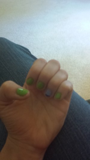 Green Sally Hansen nail polish and a light blue OPI nail polish with another dark blue Sally Hansen nail polish for accents.