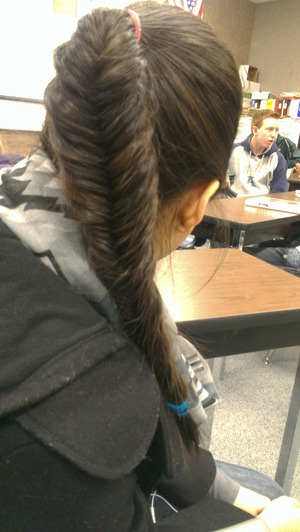 A high pony tail with a fishtail