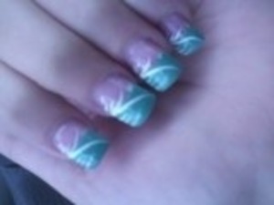 An acrylic nail inspired by the color of Tiffany's jewelry boxes. A twist on the typical French manicure, the part that is usually white is Tiffany blue with white detailing to make the nail pop