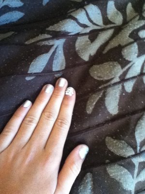 Nails using gems with a silver polish on every nail but the pointer finger on my left hand.