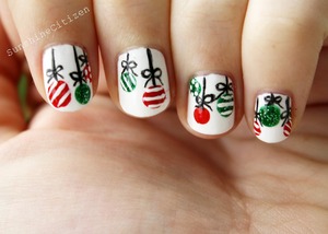 The easiest Christmas nail art I could come up with :) It's hanging Christmas tree ornaments. Check out the tutorial here- http://youtu.be/4JA-MG53GnI 

Read more here: http://www.sunshinecitizen.com/easy-christmas-nail-art/  ﻿