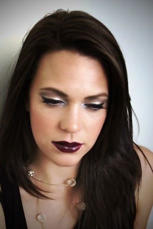 A holiday look using gold and silver pigments and a deep burgundy lip