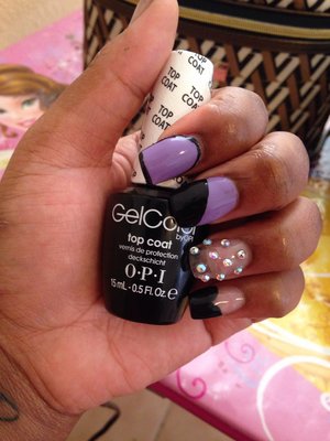 Purple and black design on acrylic nails. 
