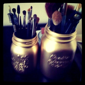 make up brush holder. spray painted mason jars gold.