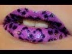 Pink lips with a black animal print on top.