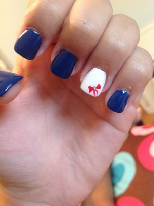 navy blue with white nail and red bow design 