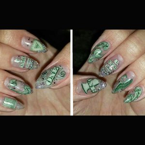 Gel stiletto set with embedded images all cut from a dollar bill. Middle finger reads "bank notes own u" 