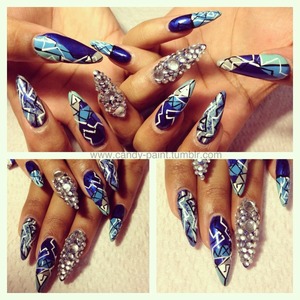 Used various shades of blue, black & white nail stripes & Swarovski crystals to create this bold look! 