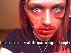 2D Zombie makeup using a Mehron bruise wheel, some fake blood and spooky contacts 