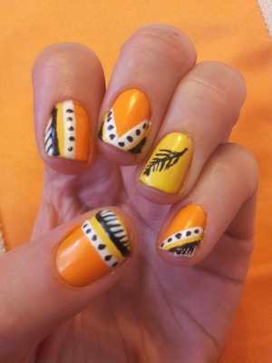 Orange, yellow, black and white patterned nails