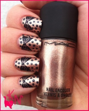 This is a mac polish with a bow design 