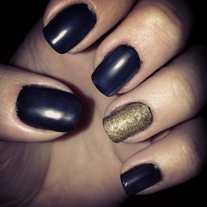 Black nail-polish with a matt finish and gold nail-polish with gold glitter on top! 