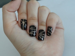 Hi! This is a design is black and gold glitter nail art. I used striping nail tape to help me with this (: 