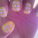 yellow nails with white stripes and silver gems