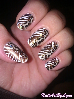 This is a zebra/leopard design. I just painted my nails in the brown glitter colour and then added the beige colour with tape. Then of course the designs are konad designs. To hide the harsh line between the zebra and leopard and also to add some glamour :) For more info and photos, please check my blog: http://nailartbylynn.tumblr.com/