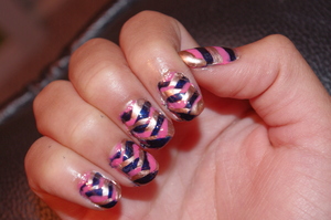 This is a recreation of missjenFABULOUS's fishtail braid nail polish tutorial which can be seen here: http://www.youtube.com/watch?v=TnVIzeqJ8ik
I did the nail look with more sections however, and thinner stripes, to give more intricacy to the look. I did smush my hand against SOMETHING right after, which is why this may look a bit messy unfortunately, although I did try to fix it. The colors I used were Essie's Penny Talk and Midnight Cami and Milani Neon Nail Lacquer in Pink Hottie