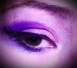 Smokey purple eyeshadow with bold black eyeliner