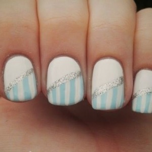 Half white nails with half blue and white stripes and a silver diagnol