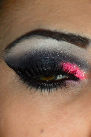 Dramatic liner black smoked out eye with a pop of hot pink glitter