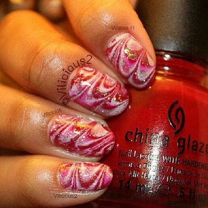 Link to website post: https://ienjoynailpolish.com/valentines-day-design-1-from-2014/

Valentine's day design number 1!!
A simple, yet pretty Valentine's day themed water marble.
For the base, I applied two coats of China Glaze Red Satin. 
And, for the water marble I used China Glaze Red Satin, China Glaze White Cap, & Zoya Purity.
After I allowed the water marble to dry a bit, I applied Sally Hansen Sparkling Rose on random areas of the design.
Then, I applied a layered of Orly Shine On Crazy Diamond.
I really liked how it came out. ^_^
