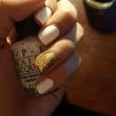 White matte nails with sparkly gold accent nail