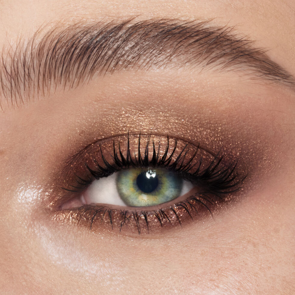 Charlotte Tilbury model wearing the Exagger-Eyes Waterproof Eyeshadow Stick in Amber Haze
